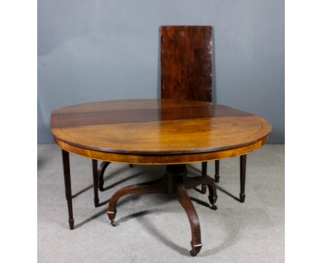 A 19th Century mahogany extending dining table inlaid with ebony stringings, comprising two D-shaped end sections, each on tu