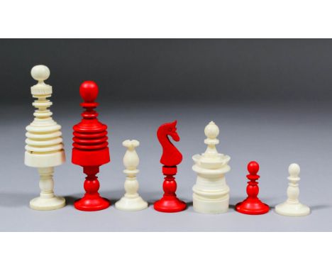 A 19th Century ivory and red stained ivory "Barleycorn" pattern chess set, Kings 3.875ins high, Pawns 1.5ins high, in wooden 
