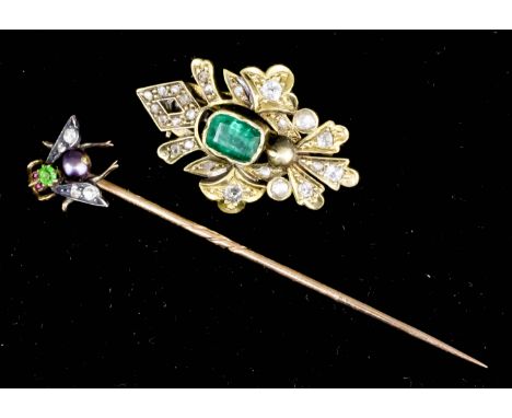 A gold coloured metal mounted pearl, peridot, garnet and rose diamond set fly pattern tie pin, contained in green leather fit