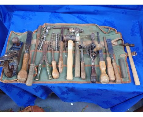 A COLLECTION OF VINTAGE WOODEN HANDLED TOOLS contained in a leather workbag, largely mid-20th century (a lot)