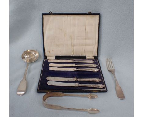 A COLLECTION OF SILVER CUTLERY including sugar tongs, one fork, a small ladle and five knives cased