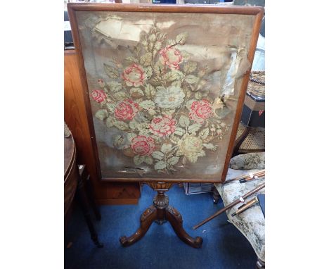 A VICTORIAN WALNUT FIRESCREEN the floral needlework screen (damaged) supported on a tripod base, 120cm high, together with a 