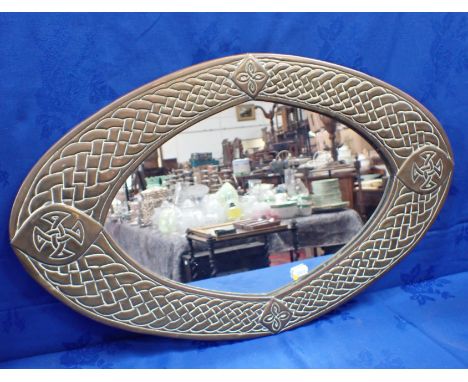 AN ARTS AND CRAFTS STYLE BRASS FRAMED MIRROR with Celtic knot and strapwork decoration 68 x 41cm