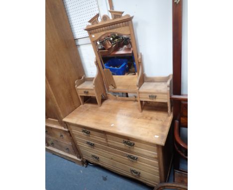 AN EDWARDIAN LIGHT OAK DRESSING TABLE the bevelled mirror and superstructure above an arrangement of drawers, approx 168cm hi