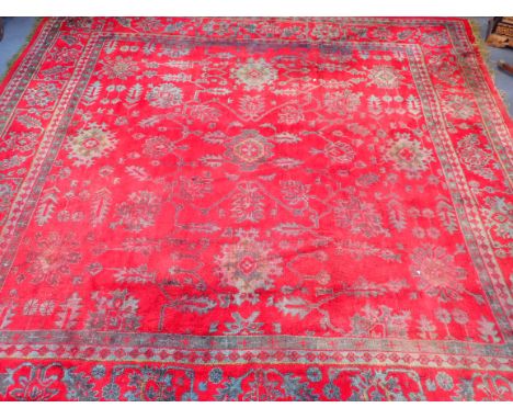 A TURKEY CARPET OF LARGE PROPORTIONS 420 x 420cm (wear, uneven fading, a large section cut out and stitched back in)