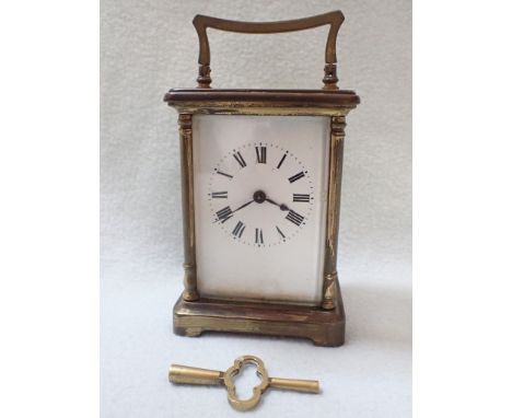 A BRASS-CASED CARRIAGE CLOCK (needs attention, small chips to glasses)