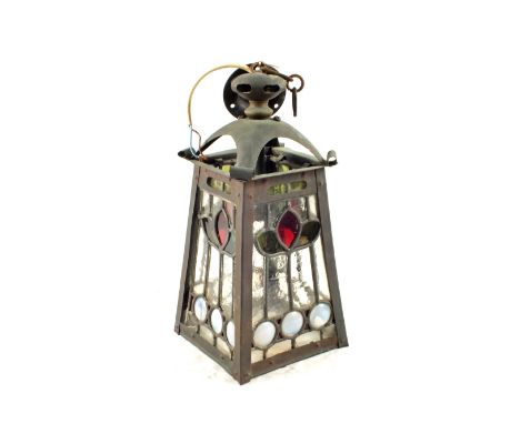 An Art Nouveau hanging Copper lantern with four lead stained glass panels bearing stylised tulips, 13 1/2" high