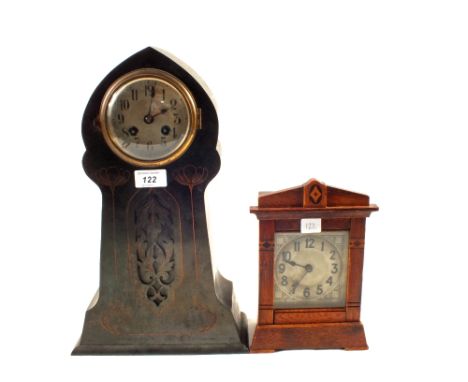 An Art Nouveau metal cased mantel clock with floral decoration and a wooden cased mantel clock