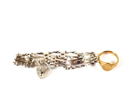 A Silver gate bracelet with a 9ct Gold ring