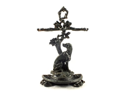 A Victorian Iron stick stand with dog and tree decoration