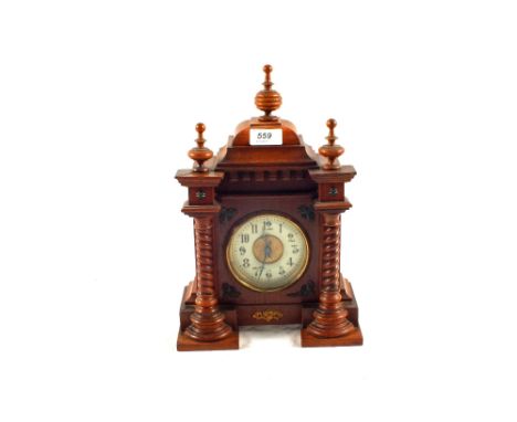 A carved Mahogany mantel clock