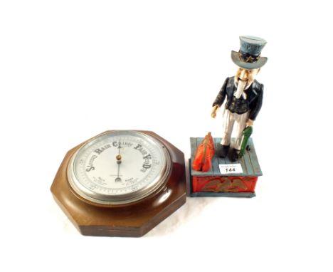 A circular barometer and reproduction Uncle Sam mechanical money box