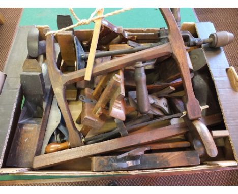 A box of various vintage woodworking tools