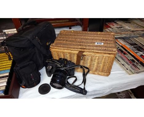 A wicker basket, a 2 Lowepro camera bag, a Lowepro camera case &amp; a Canon camera