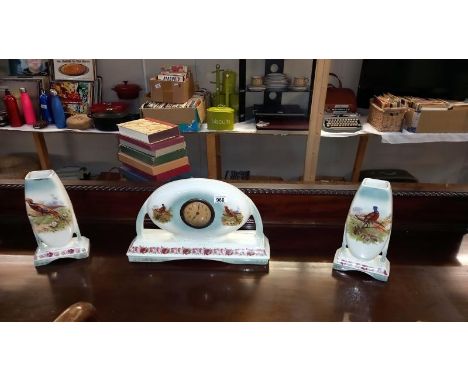 A 1930's pottery clock set decorated with flowers &amp; pheasants A/F (movement incomplete)&nbsp;