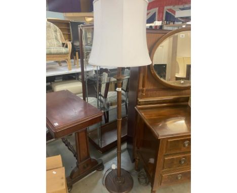 A wooden standard lamp