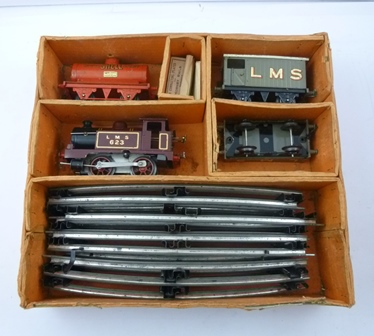 A 1950's HORNBY O GAUGE CLOCKWORK TRAIN SET comprising an LMS 623 0-4-0 ...