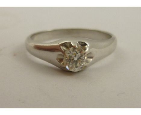 A DIAMOND SOLITAIRE having old cushion cut set in white gold coloured metal tapered setting, size N 