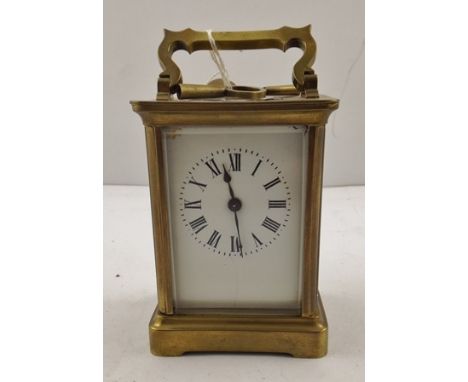 A 20TH CENTURY FRENCH GILT BRASS CARRIAGE TIMEPIECE, having shaped swing handle, movement with platform cylinder escapement f