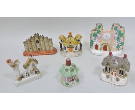 A 19TH CENTURY STAFFORDSHIRE POTTERY INKWELL in the form of a cottage, with a dog and a tree, 12cm high, together with two St