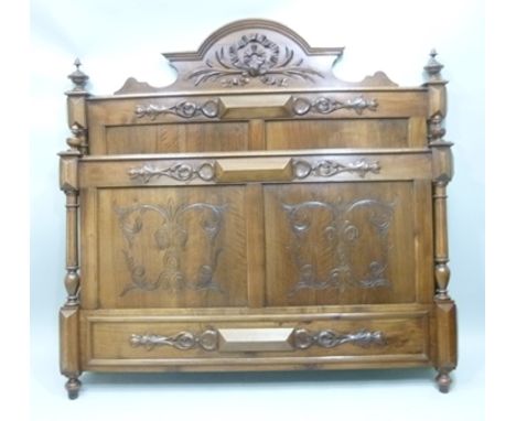 A 19TH CENTURY FRENCH WALNUT BED having bow carved relief head and foot boards, with irons, 1.43m wide 