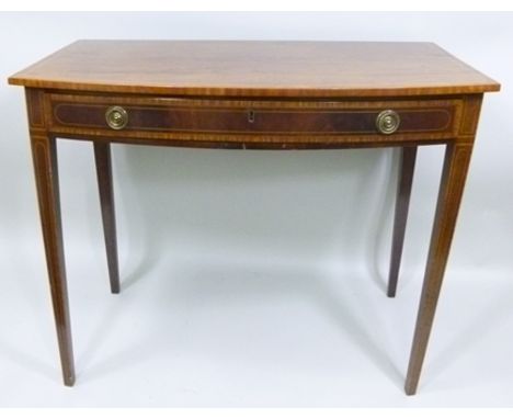 A 19TH CENTURY MAHOGANY SIDE TABLE having boxwood crossbanded bow fronted top over a satinwood crossbanded frieze drawer, rai