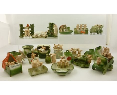 A COLLECTION OF TWENTY GERMAN CERAMIC NOVELTY PIG ORNAMENTS predominantly pink and green palette 