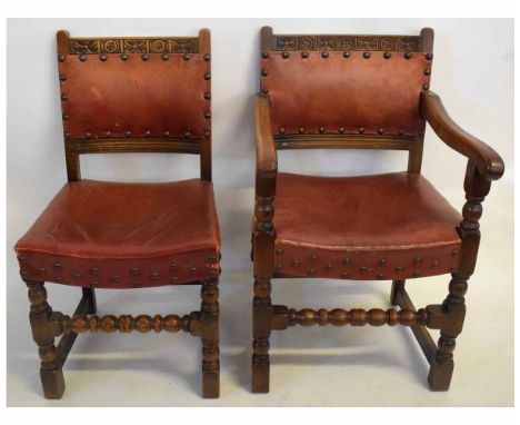Set of six 20th century oak dining chairs with leather upholstered seat and back with button detail and carved top rail on a 