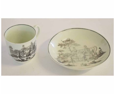 An 18th century Worcester cup and saucer black printed with the tea party design, the saucer 12cm diam 