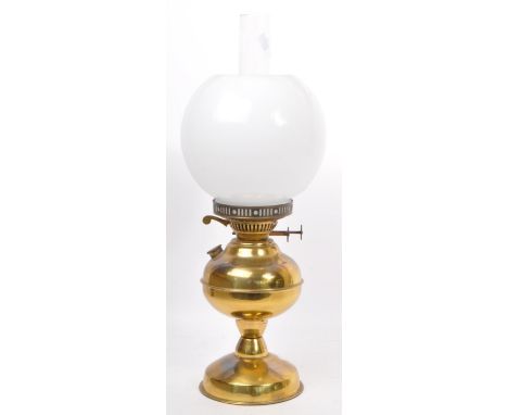A vintage 20th century brass oil lamp. Having a white opaque cylindrical glass shade, with a glass flute atop a lamp base wit