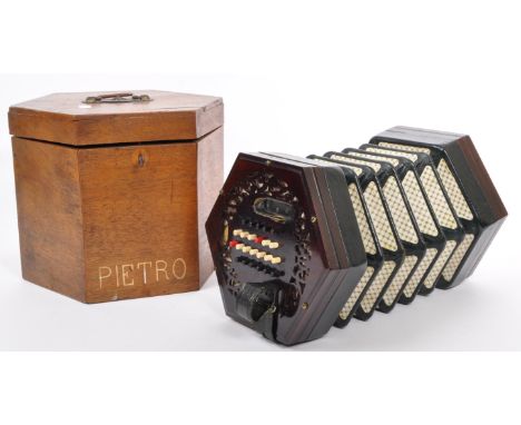 An early 20th Century Lachenal &amp; Co concertina squeeze box of hexagonal form having pierced decoration mahogany case with