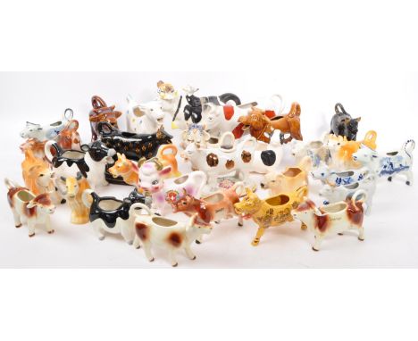 A collection twenty nine 20th Century ceramic milk / cream pouring cows / jugs. To include a variety of colourways, sizes and
