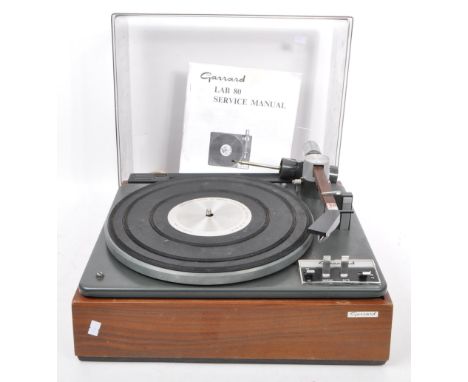 A vintage 1960's LAB 80 MK2 vinyl turntable / record player by GARRARD. With teak wood casing and needle arm, smoked plexigla