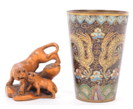A 20th century Japanese signed fruitwood netsuke in the for m of a prowling tiger and cub with bead eyes, carved with signatu