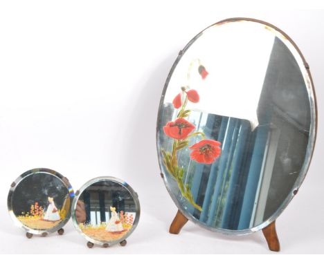An early to mid 20th century set of three (triptych) hand painted oval mirrors. The larger mirror having a poppy design to ce