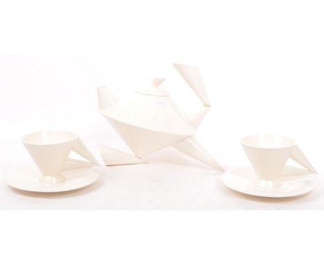 An Art Deco era inspired late 20th century three piece tea service comprising of tea pot, cups & saucers in white colourway. 