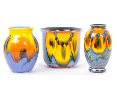 A collection of two vintage 20th century studio pottery vases alongside a studio pottery planter. The lot includes a Poole Po