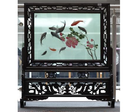 A late 19th/Early 20th Century hardwood fire screen with needlework panel of fish