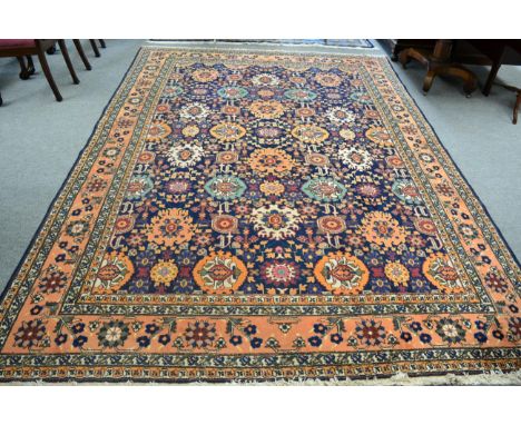 Tabriz carpet, Persian Azerbaijan, the indigo field with an allover design of large stylised flowerheads enclosed by pale apr