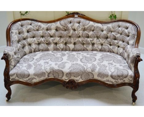 A Victorian button-upholstered sofa with mahogany frame