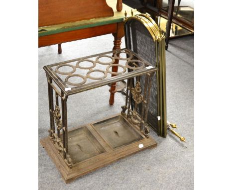 ~ A Victorian cast iron stick stand with drip trays, a spark guard, fire tongs, shovel and poker 