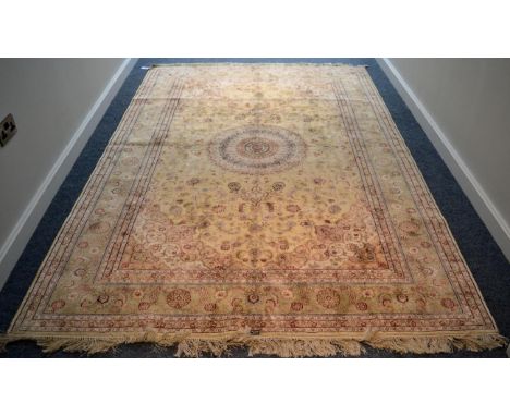 * An Oriental silk carpet, probably China, the cream field of scrolling vines around a radiating medallion, framed by spandre