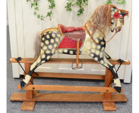 ^ A wooden painted rocking horse 