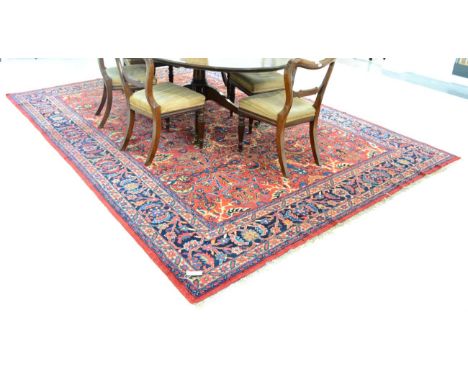 Mahal carpet, West Persia, the brick red field with an allover design of stylised plants enclosed by deep indigo borders of s