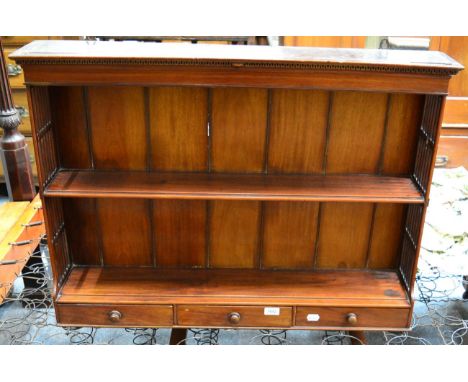 A George III style mahogany wall shelf with three base drawers 