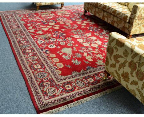 *An Indian carpet of late 16th century Moghul design, The raspberry field with a one way design of naturalistic flowering pla