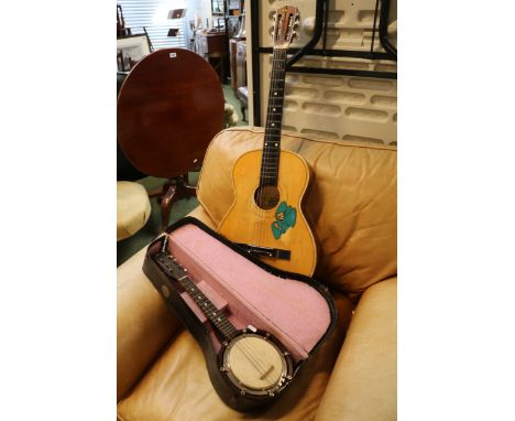 Cased English Made banjolele and a Chinese Acoustic Guitar 