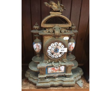 19th century gilt brass mantel clock with painted porcelain panels and wooden base 