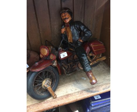 A model of a motorcycle rider on vintage Harley Davidson. 