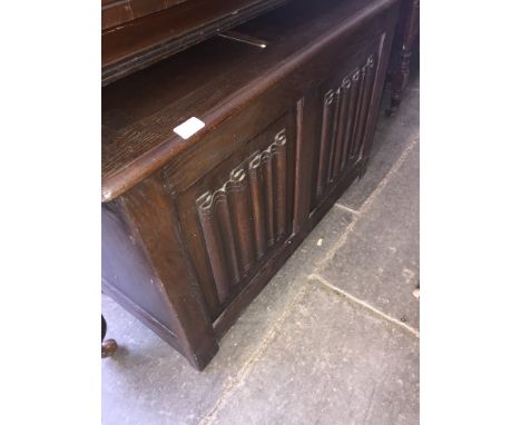 An oak linen fold paneled trunk 